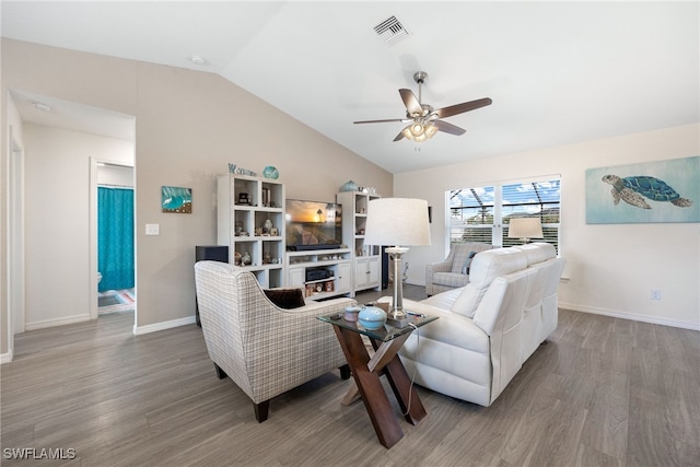 living room with ceiling fan, vaulted ceiling, and wood-type flooring