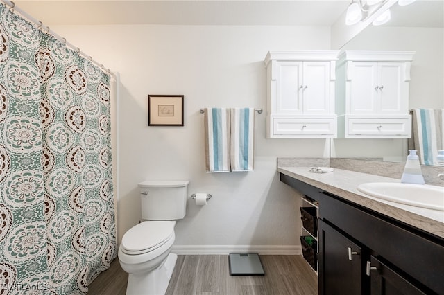 bathroom with vanity, hardwood / wood-style floors, and toilet