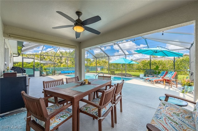 view of patio / terrace with a fenced in pool, a lanai, and ceiling fan