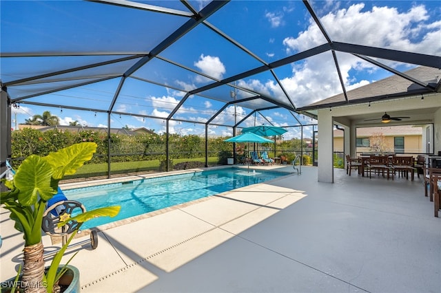 view of swimming pool featuring a lanai, a patio, and ceiling fan