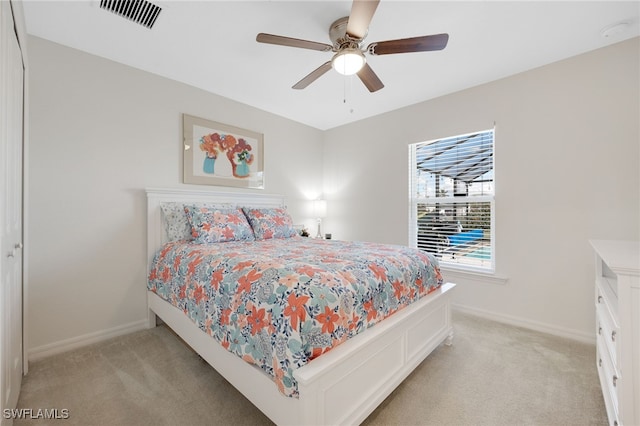 bedroom featuring light colored carpet and ceiling fan