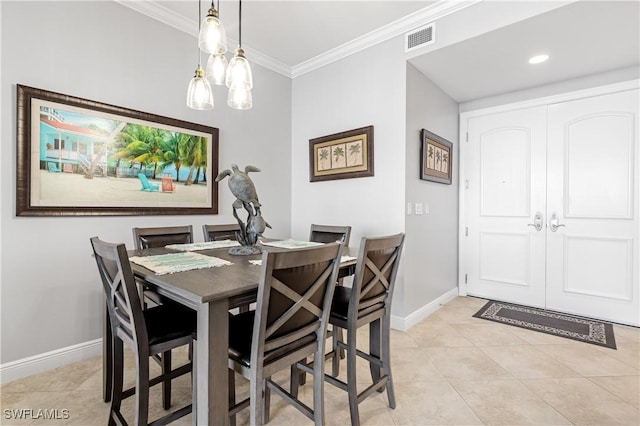 dining area with light tile patterned floors, visible vents, baseboards, ornamental molding, and an inviting chandelier