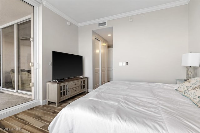 bedroom featuring wood finish floors, crown molding, visible vents, access to outside, and baseboards