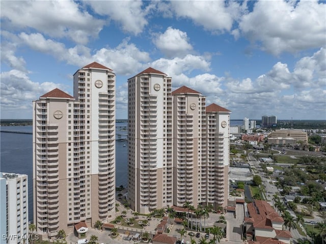 view of property with a water view and a city view