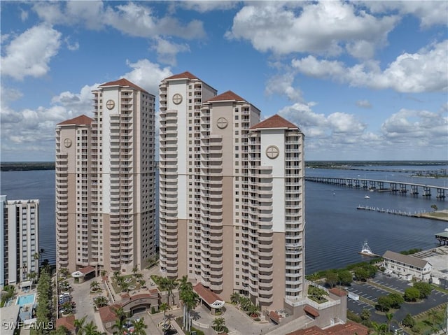 view of property with a water view and a city view