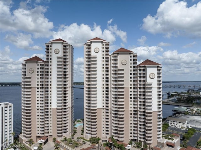 view of building exterior with a water view and a city view