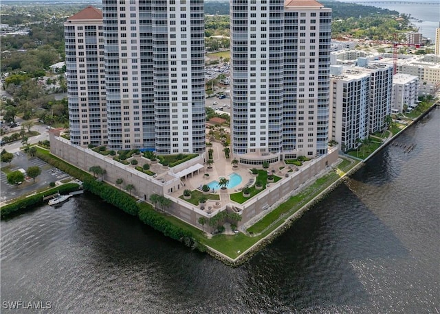 drone / aerial view featuring a view of city and a water view