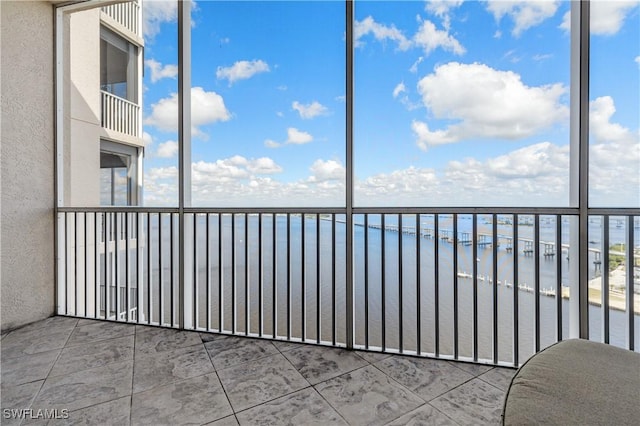 unfurnished sunroom featuring a water view