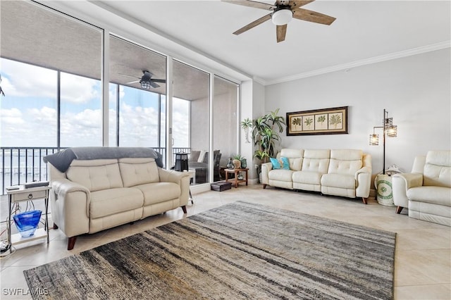 living area with a ceiling fan, floor to ceiling windows, crown molding, and light tile patterned floors