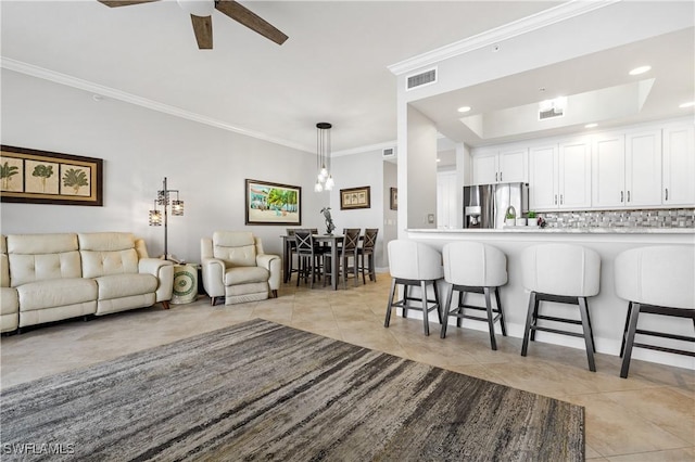 kitchen with light countertops, a kitchen bar, and white cabinets