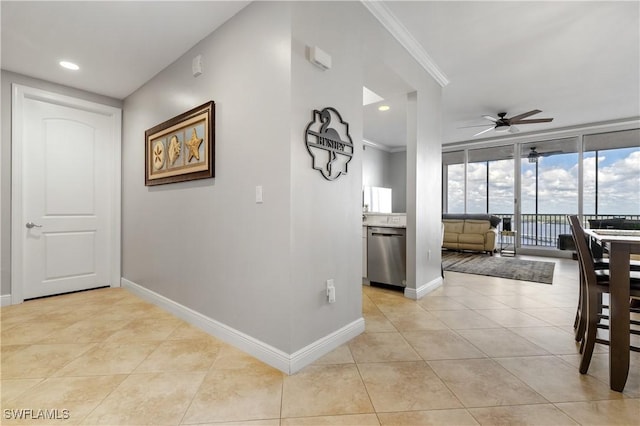 corridor featuring recessed lighting, baseboards, crown molding, and light tile patterned flooring