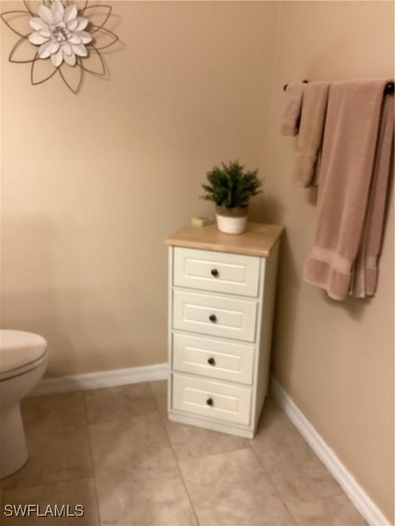 bathroom featuring tile patterned floors and toilet