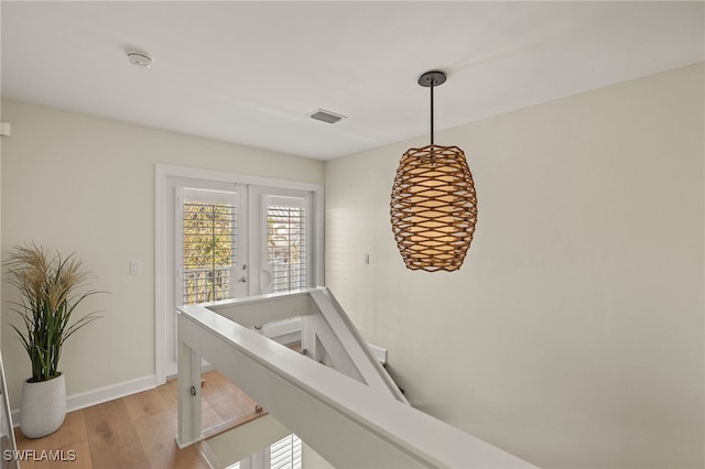1 Sunset Captiva Ln, Captiva, FL 33924 - hall featuring light wood-type flooring, baseboards, and french doors
