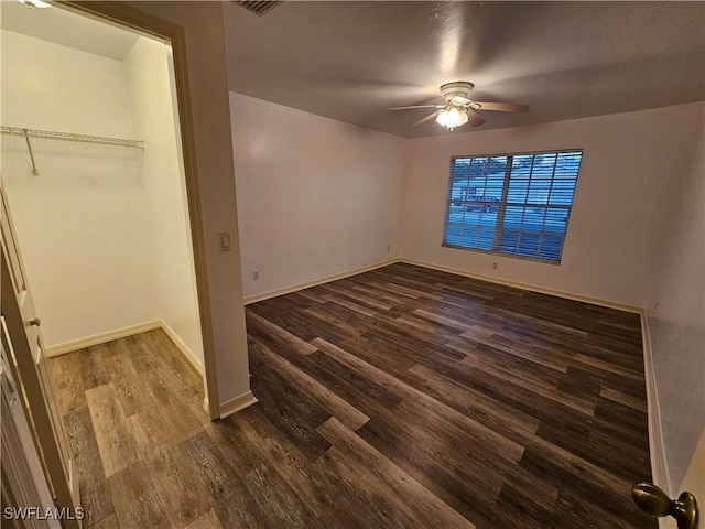 unfurnished bedroom featuring ceiling fan and dark hardwood / wood-style floors