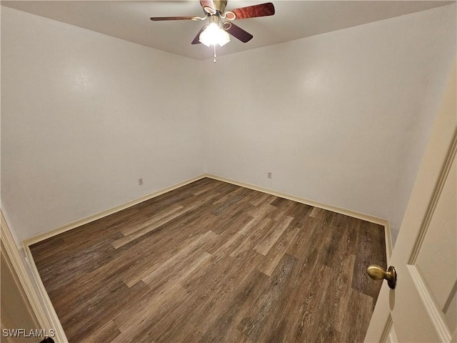 spare room with ceiling fan and dark hardwood / wood-style flooring