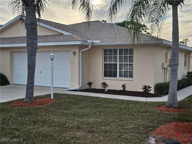 single story home with a yard and a garage