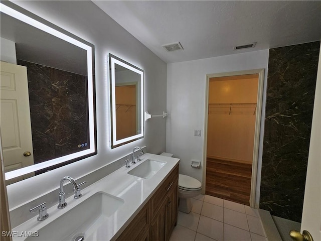 bathroom with tile patterned floors, vanity, and toilet