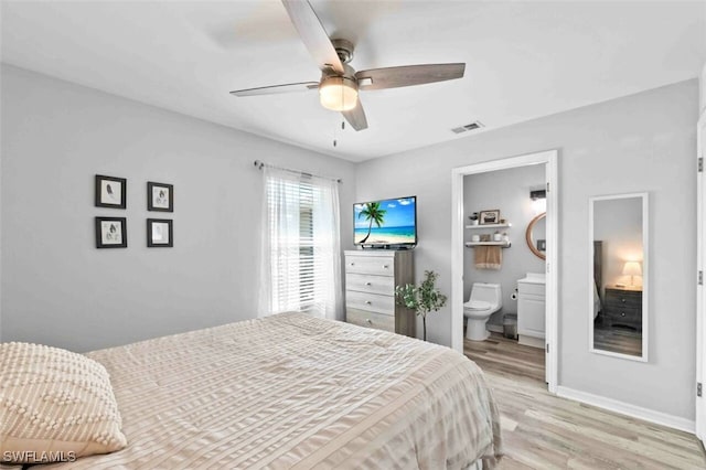 bedroom with connected bathroom, ceiling fan, and light hardwood / wood-style flooring