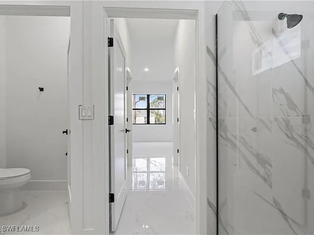 bathroom featuring toilet and a shower with shower door