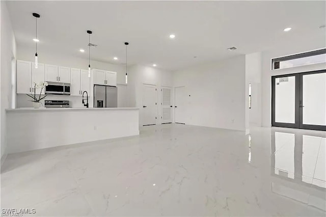 unfurnished living room with french doors and sink