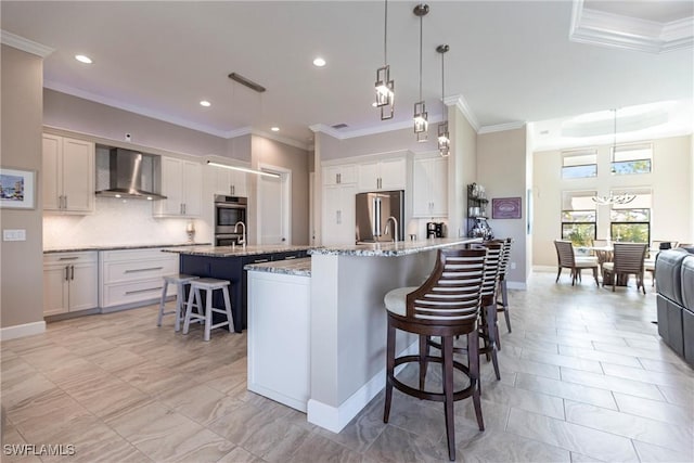 17122 Barcrest Ln, Punta Gorda, FL 33955 - kitchen with a kitchen island with sink, ornamental molding, appliances with stainless steel finishes, wall chimney exhaust hood, and a kitchen bar