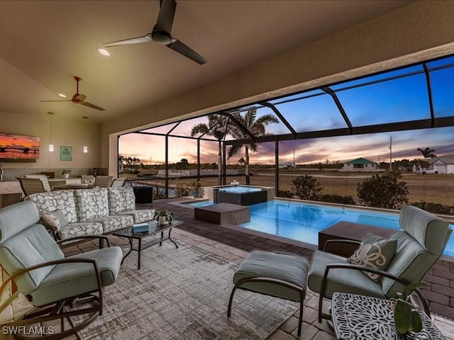 exterior space featuring a patio area, ceiling fan, glass enclosure, and an outdoor living space