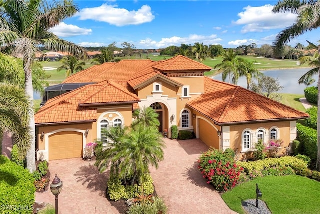 view of front of home featuring a garage, a lanai, and a water view