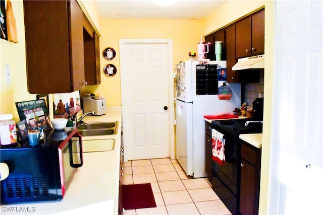 kitchen featuring light countertops, electric range, light tile patterned flooring, and under cabinet range hood