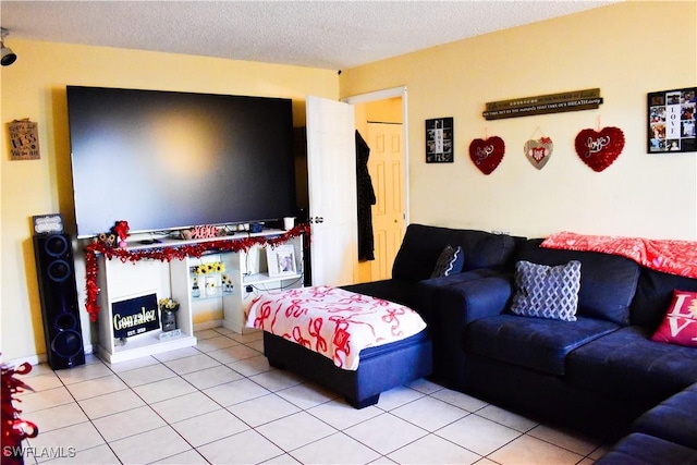 living area featuring light tile patterned floors and a textured ceiling