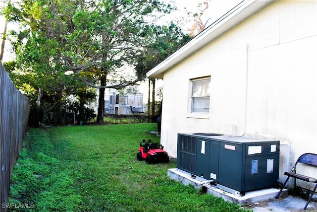 view of yard with fence and cooling unit