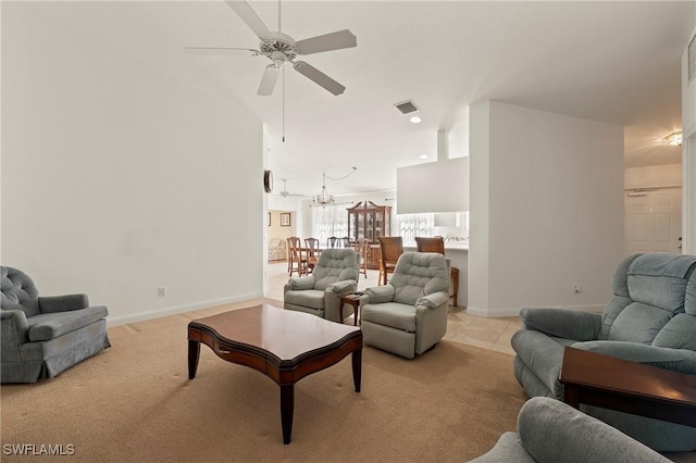 carpeted living room with ceiling fan with notable chandelier