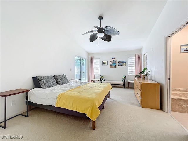 carpeted bedroom with multiple windows, vaulted ceiling, and ceiling fan