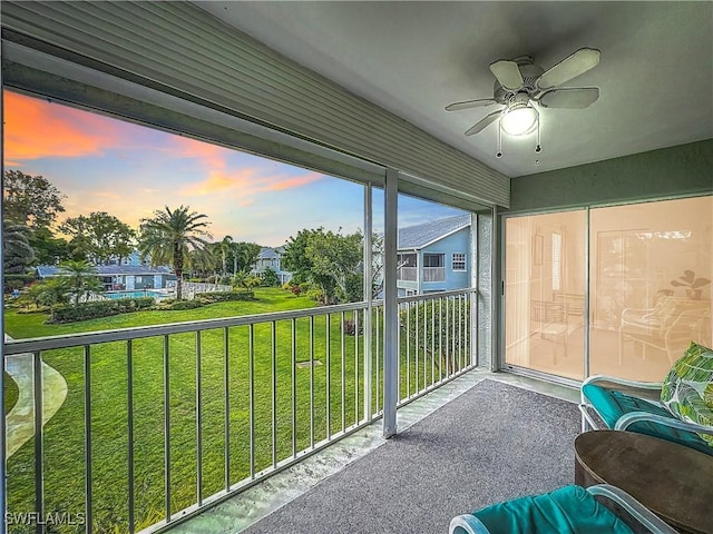 sunroom featuring ceiling fan