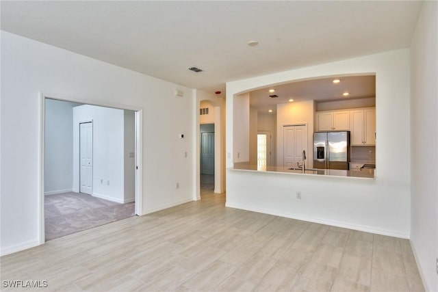 2591 Vine Ave, Naples, FL 34120 - unfurnished living room with sink and light hardwood / wood-style floors