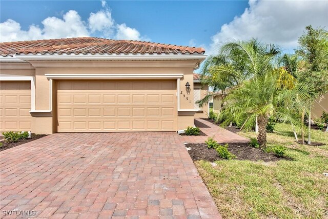 2591 Vine Ave, Naples, FL 34120 - view of front facade featuring a garage