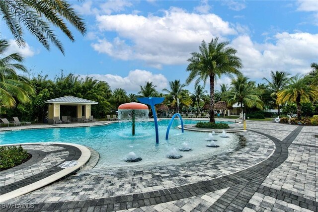 2591 Vine Ave, Naples, FL 34120 - view of pool featuring a patio, a gazebo, and pool water feature