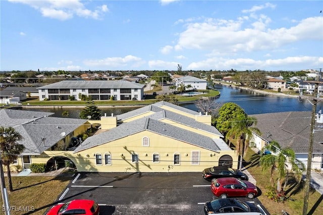 drone / aerial view with a residential view and a water view