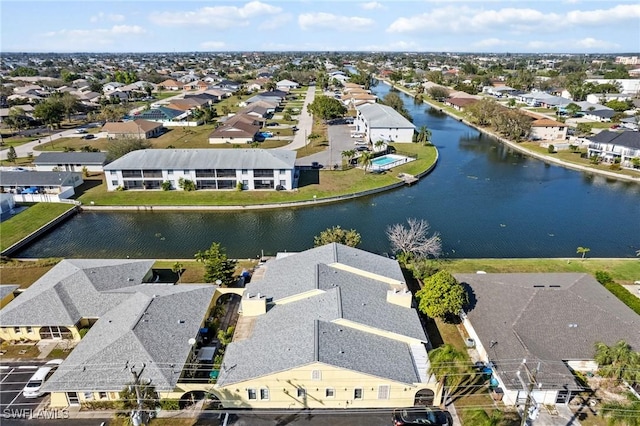 bird's eye view featuring a water view and a residential view