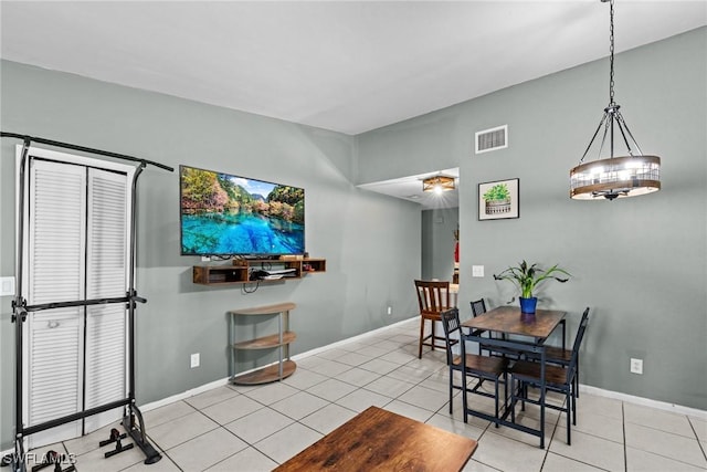 dining space featuring light tile patterned floors, baseboards, and visible vents