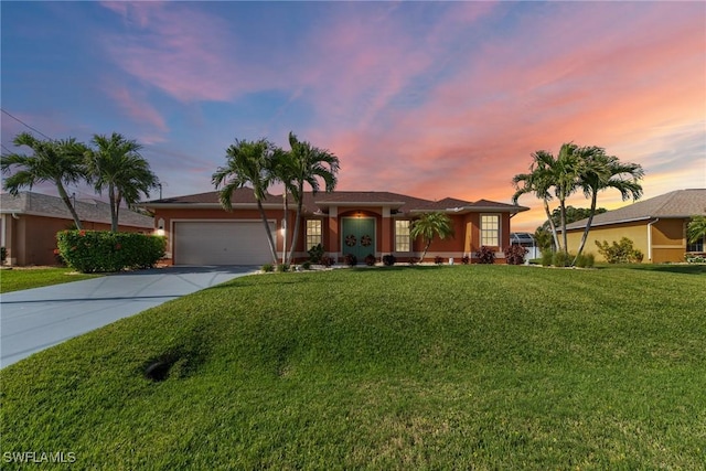 ranch-style home with a garage, a yard, and driveway