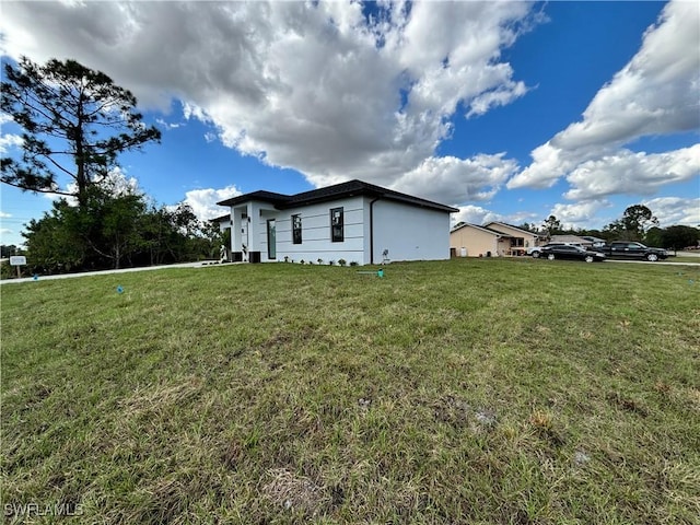 view of home's exterior with a lawn