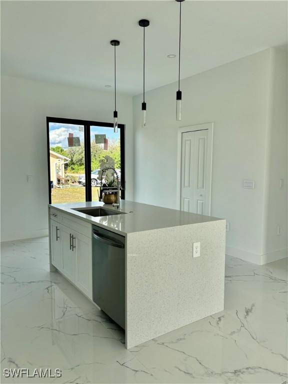 kitchen with sink, a kitchen island with sink, hanging light fixtures, white cabinets, and stainless steel dishwasher