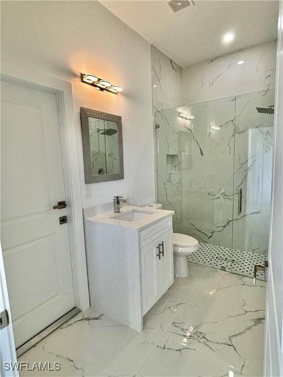 bathroom with vanity, toilet, and a shower with door