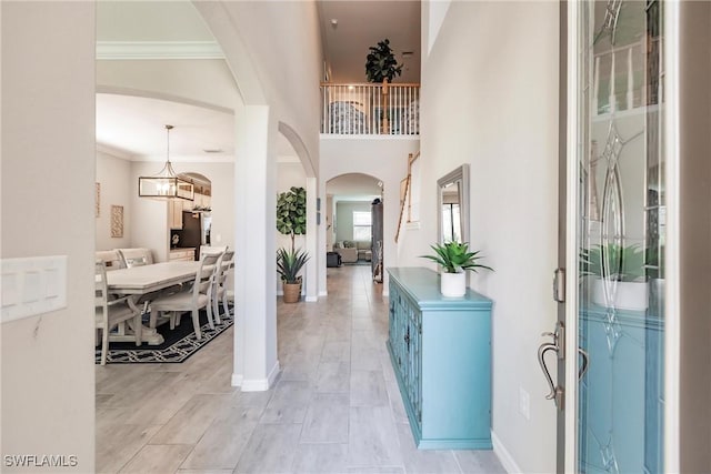 entrance foyer with ornamental molding and light hardwood / wood-style floors