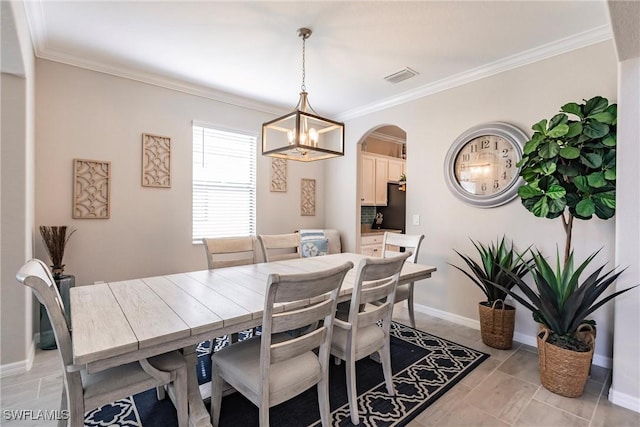 dining area featuring ornamental molding and a chandelier