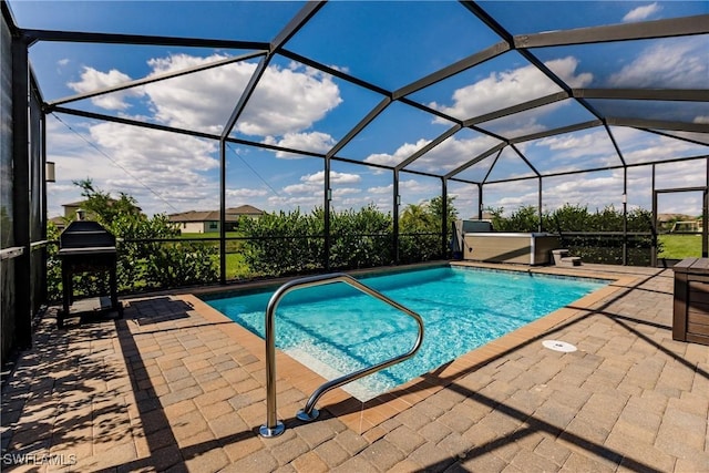 view of pool featuring grilling area, glass enclosure, and a patio area