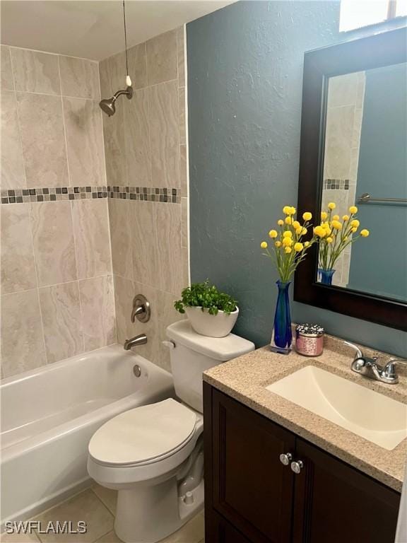 bathroom featuring shower / bath combination, a textured wall, toilet, vanity, and tile patterned floors