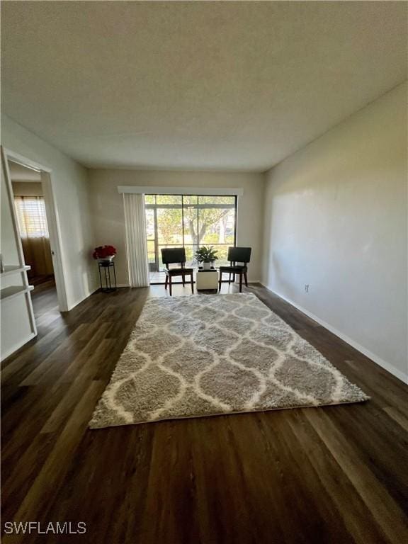 unfurnished room with dark wood finished floors