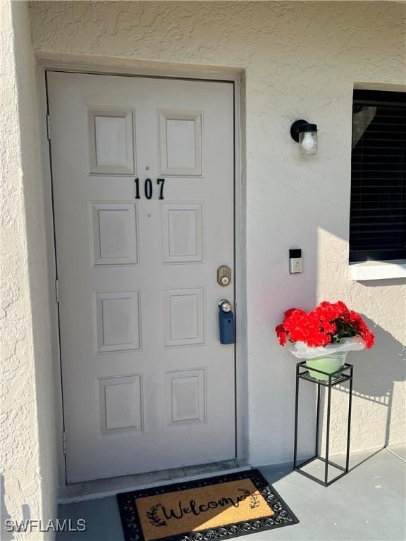 property entrance featuring stucco siding