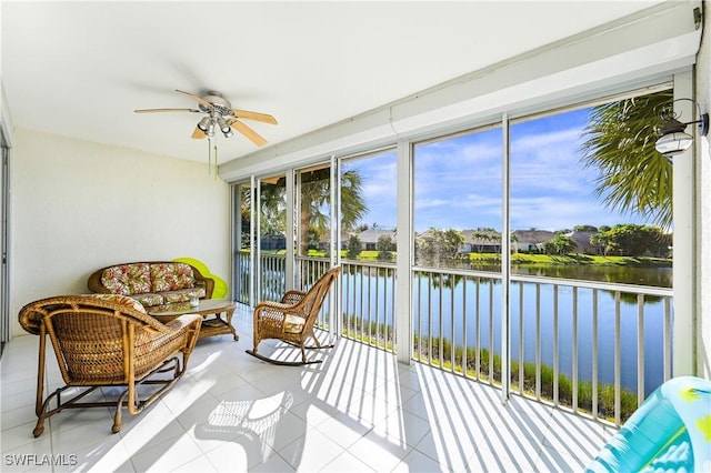 sunroom with a water view and ceiling fan